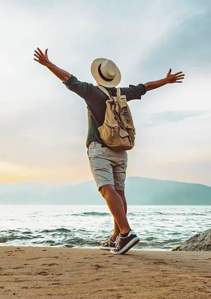 Man on Beach With Hands Up